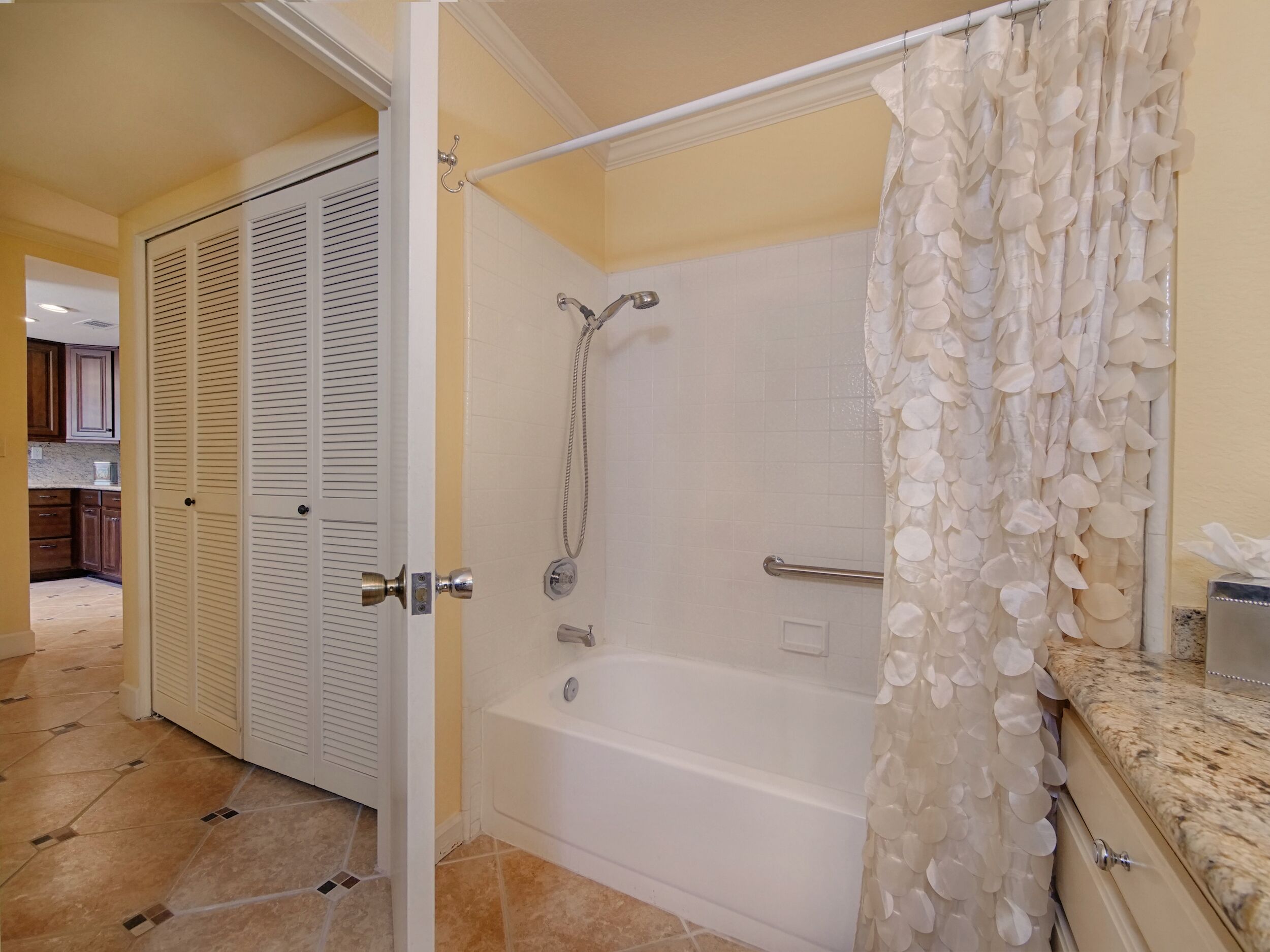 A bathroom with a bathtub, shower, and a toilet.