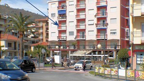A multi-story hotel with balconies, a parking area, and a street view. - Doria 6 Int 5 in Marina di Andora (Andora)