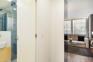 Relax in a stylish apartment with a comfortable sofa, coffee table, and large window.
