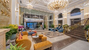 A luxurious lobby with a grand chandelier, plush seating, and a staircase. - Paracel Beach Hotel (Da Nang)