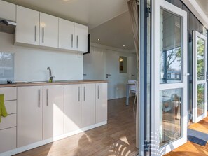 Kylskåp, mikrovågsugn, barnstol och grytor/köksredskap