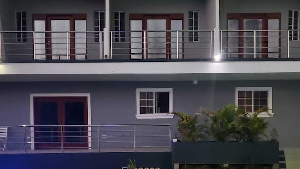 A two-story building with a pool area.