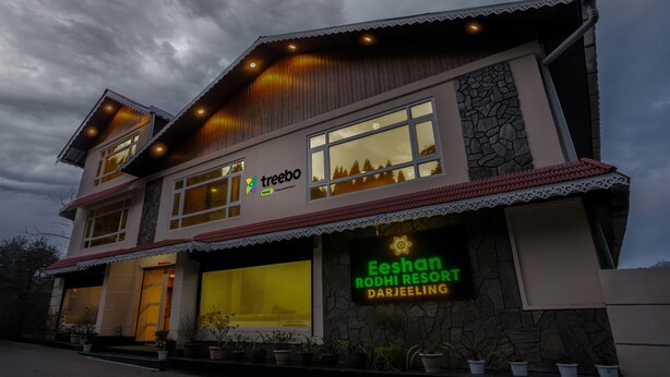 A two-story building with a sign for Eeshan Rodhi Resort Darjeeling. - Treebo Eeshan Rodhi Resort, Darjeeling (Darjeeling)
