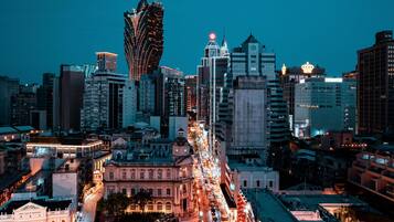 A cityscape with a prominent modern skyscraper and historic buildings.