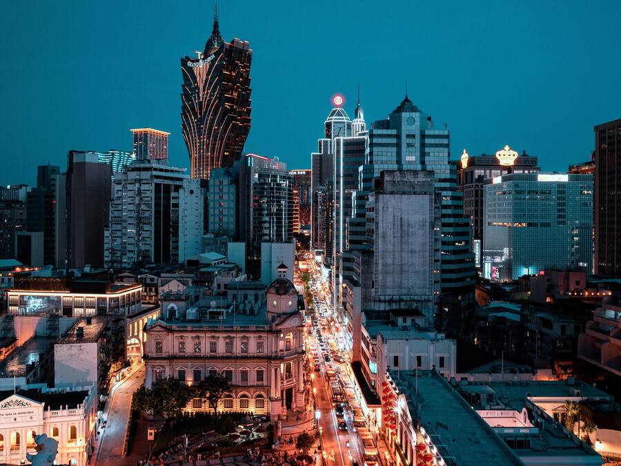 A cityscape with a prominent modern skyscraper and historic buildings.