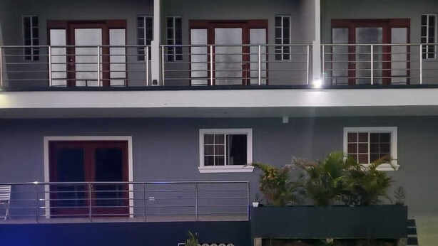 A two-story building with a pool area. - Beausejour Buena Vista Suite 4 (Gros Islet)