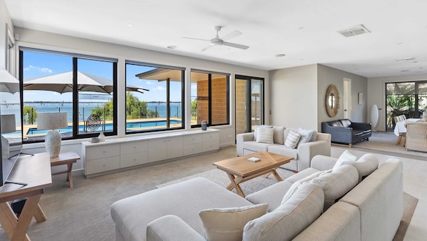A spacious living room with a large window, a ceiling fan, and a view of the outdoors. - The Rosemary Lakehouse - Spring Offer (Yarrawonga)