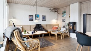 A cozy living room with a sofa, two armchairs, a coffee table, and a fireplace. - "Eljene" - 700m from the sea by Interhome (Pandrup)