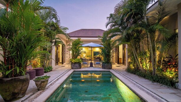 A pool area with a tiled floor, surrounded by potted plants and palm trees. - Villa Eleni - Your Private Oasis in Seminyak - A Hosted Luxury Boutique Villa (Seminyak)