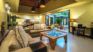 A spacious living area with a sofa, coffee table, and a view of the outdoor patio. - Villa Eleni - Your Private Oasis in Seminyak - A Hosted Luxury Boutique Villa (Seminyak)