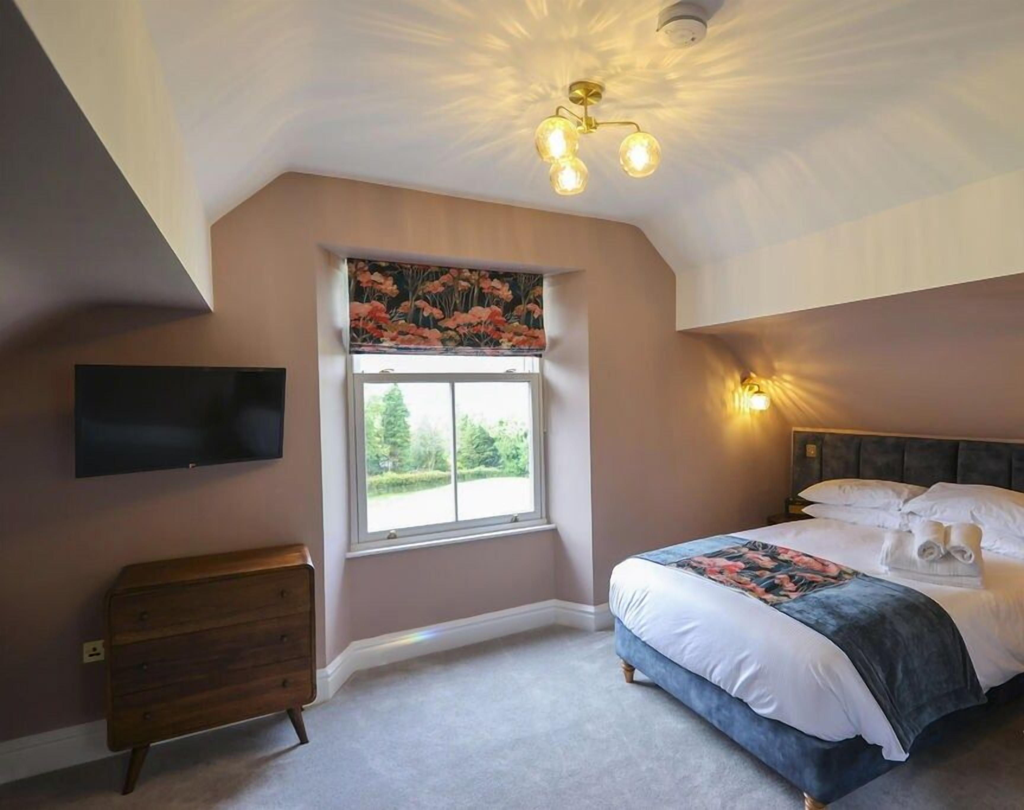 Discover comfort in one of Windermere's top-floor bedrooms – a spacious double with ensuite, offering ample room for a relaxing stay in luxurious surroundings.
