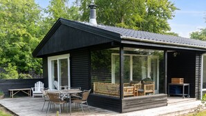 A modern cabin with a deck, outdoor seating, and a chimney. - "Josef" - 1.4km from the sea by Interhome (Nykøbing Sj)