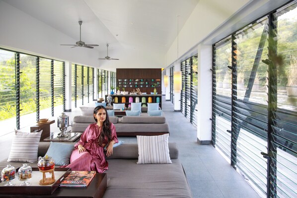 A spacious living area with a sofa, coffee table, and decorative items.