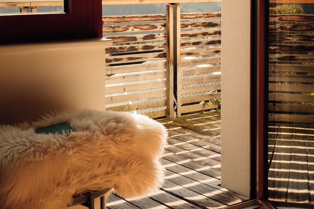 A room with a view of mountains through a glass door.