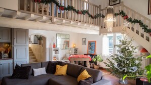 A cozy living room with a grey sofa, a wooden staircase, and a decorated Christmas tree. - Holiday rental with pool SAINT CHAMAS LS7-440. (Saint-Chamas)