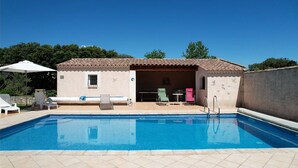 A swimming pool with lounge chairs and a covered seating area. - Vacation rental house with pool AUREILLE LS1-439 (Aureille)