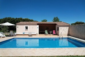 A swimming pool with lounge chairs and a covered seating area. - Vacation rental house with pool AUREILLE LS1-439 (Aureille)