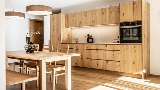 A modern kitchen with wooden cabinetry, a built-in oven, and pendant lighting. - HUUS123, Apartment 3 (Au)