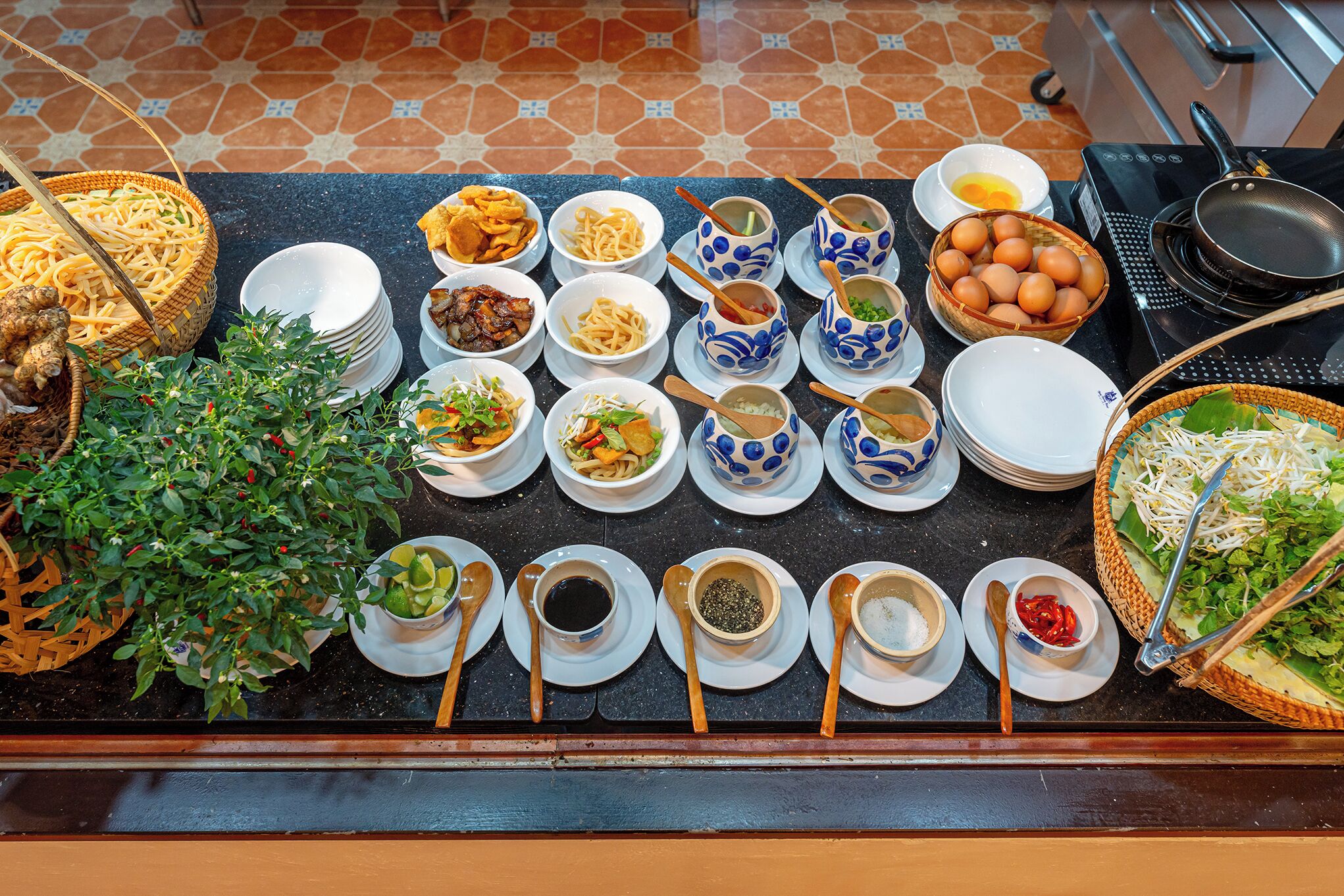 A buffet table with various dishes and condiments.