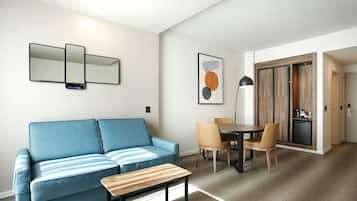 Un soggiorno moderno con un divano blu, un tavolino in legno e un'area pranzo con tavolo e sedie.