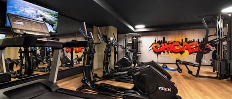 A gym with treadmills, elliptical machines, and weight machines.