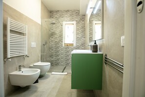 A modern bathroom with a bidet, toilet, and shower. - Etna Mare Apartments by Wonderful Italy (Augusta)
