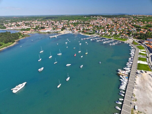Stunning marina views surround this waterfront property, offering a serene atmosphere and access to a paved walkway.