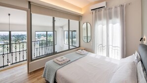 A modern bedroom with a large bed, a balcony with a view, and an air conditioning unit. - Elthea Villa 2 in Apolpena, Lefkada (Lefkada)