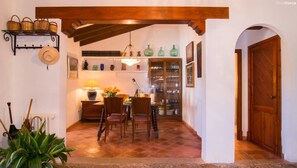 Enjoy a warm and inviting dining space with a rustic charm, complete with a dining table, comfortable chairs, and a cozy lamp.