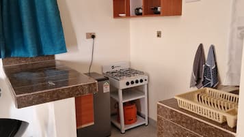 Comfort Apartment | Private kitchen | Full-size fridge, stovetop, cookware/dishes/utensils, cleaning supplies