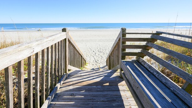 A wooden boardwalk leading to a beach with a clear view of the ocean. - Oceanfront 2 BR Condo with a Shared Pool! Channel Marker 204 (Surfside Beach)