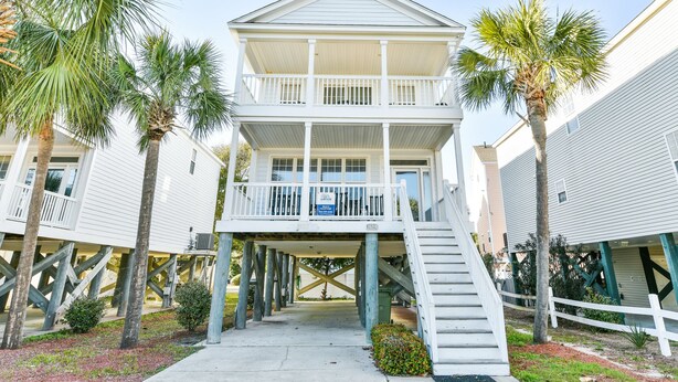 A two-story building with a balcony on the upper floor, supported by stilts. - 2nd Row 4 BR Beach House! Dream Weaver (Surfside Beach)