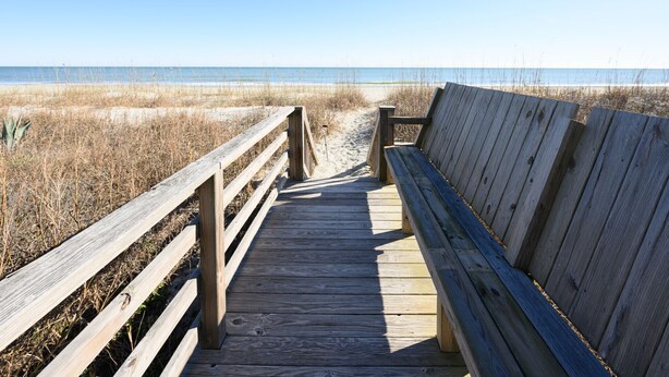A wooden boardwalk leading to a beach with a bench. - Oceanfront 3 BR Condo with a Shared Pool! Surfside By The Sea II 202 (Surfside Beach)