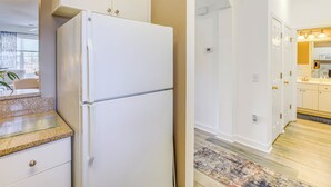 A modern kitchen with white cabinetry, a granite countertop, and a white refrigerator. - Swim, Golf & Unwind: Barefoot Resort Condo (North Myrtle Beach)