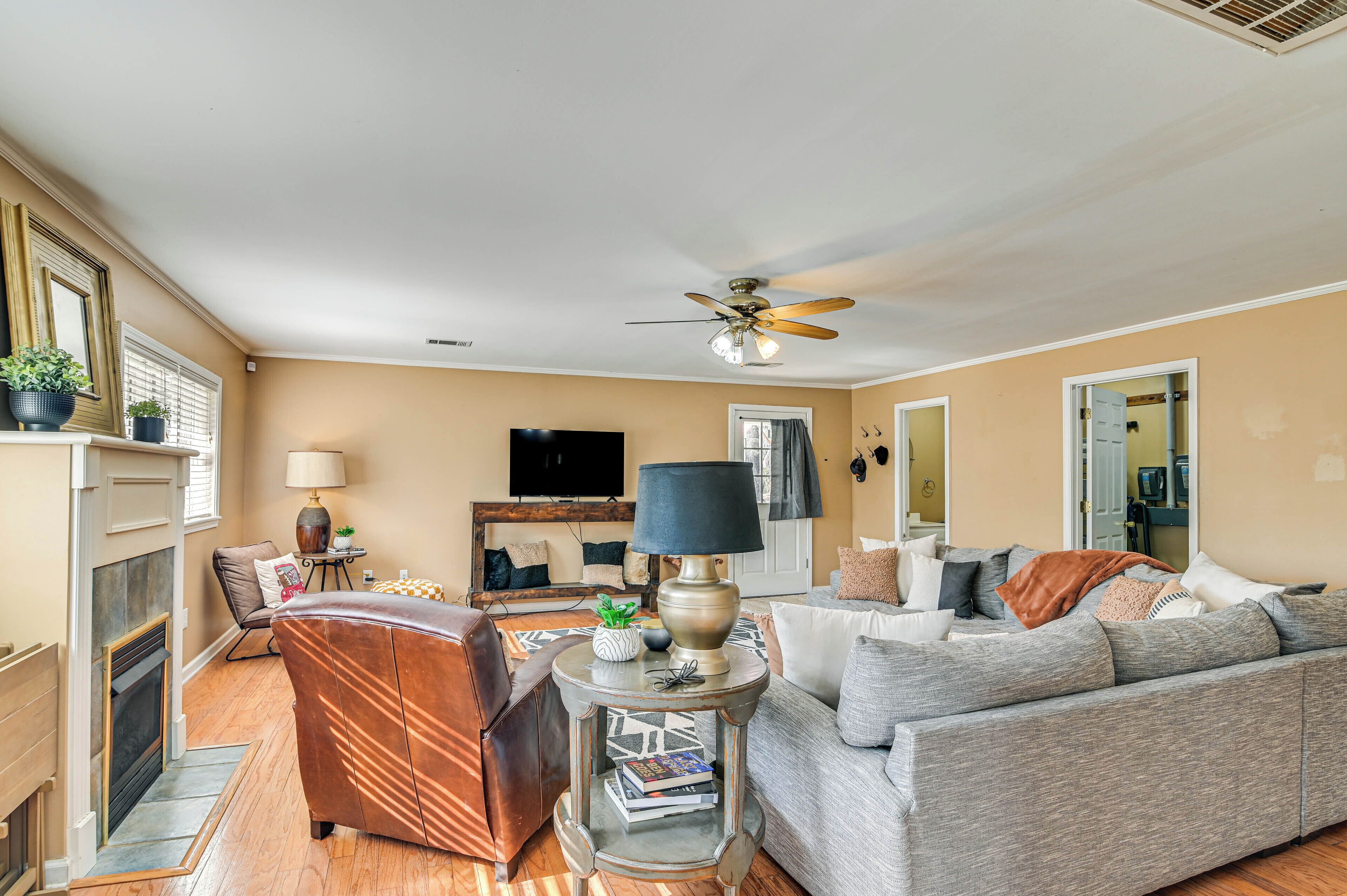 A living room with a fireplace, a sofa, a coffee table, and a television.