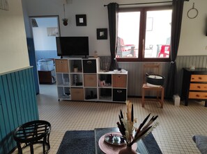 Cozy living space with a TV, comfortable seating area, and ample storage.