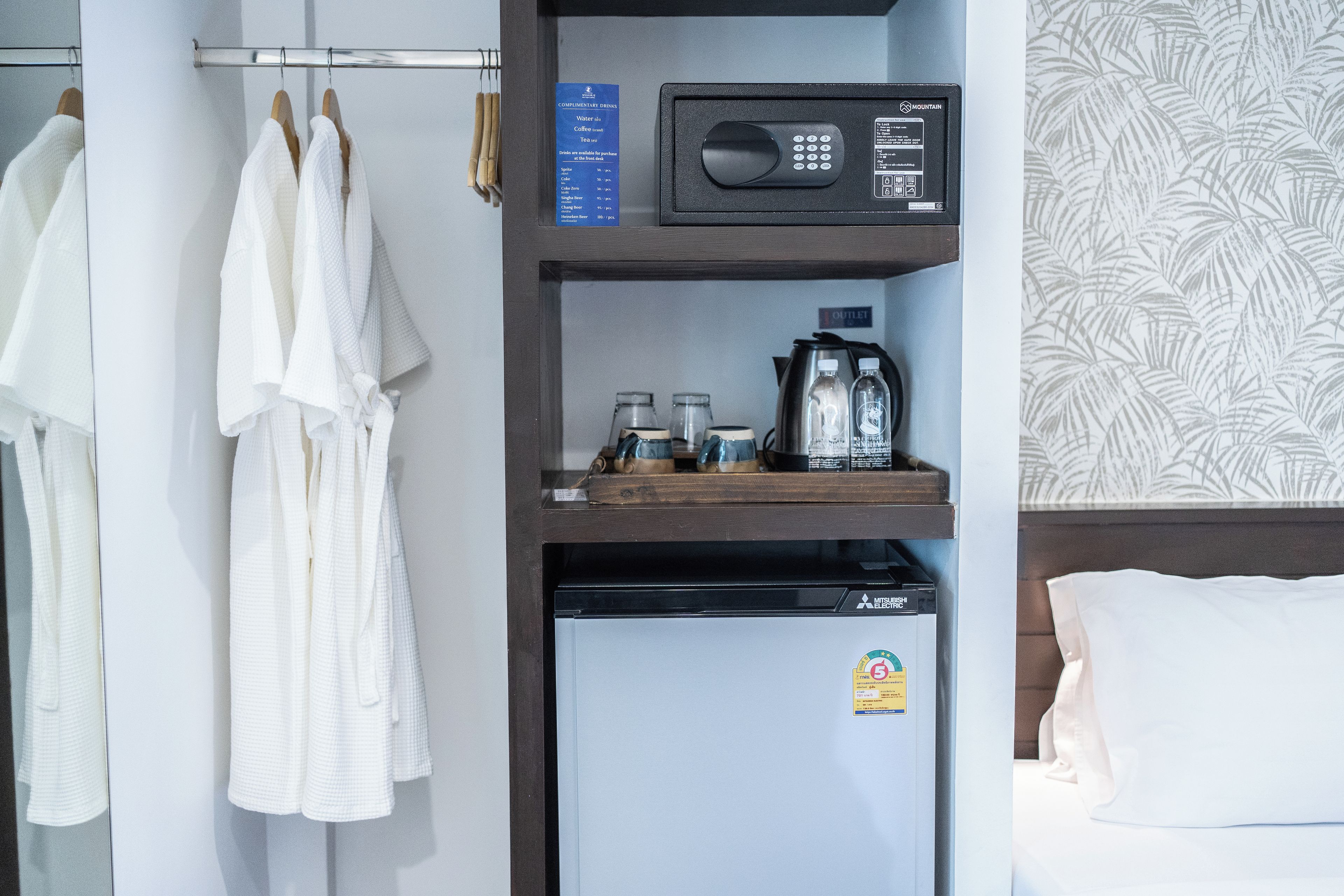 A hotel room with a minibar, a microwave, and a refrigerator.