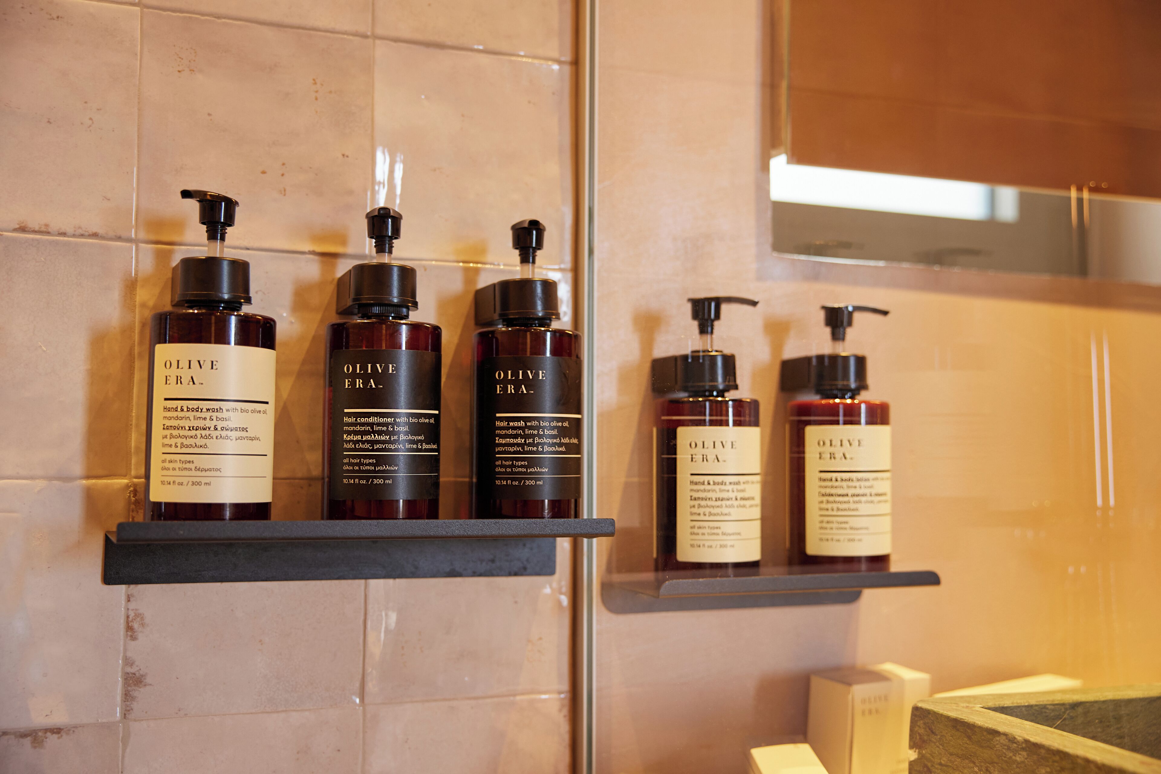 A bathroom with shelves holding olive oil products.