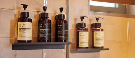 A bathroom with shelves holding olive oil products.