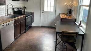 A modern kitchen with a dishwasher, oven, microwave, and wooden countertop. - The Modern beach bungalow. 7 minutes to ocean front, full private home!  (Virginia Beach)