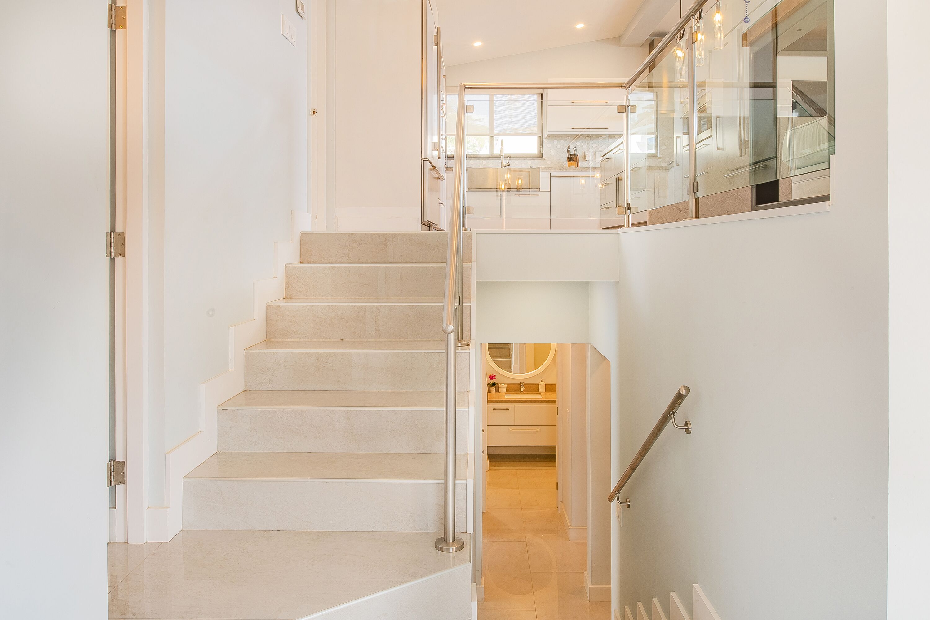 A modern interior with a staircase leading to a second-floor area.