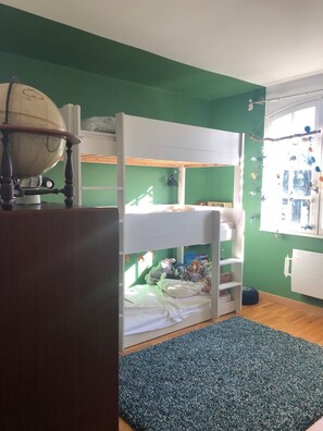 Cozy bedroom with a bunk bed and a globe for little explorers.