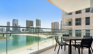 A balcony with a view of a beach and cityscape. - WelHome - Reem Diamond Residence (Abu Dhabi)