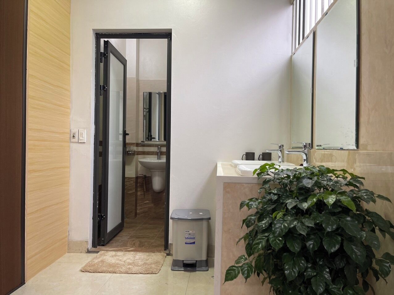 A bathroom with a sink, mirror, and toilet.