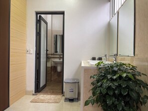 A bathroom with a sink, mirror, and toilet. - Nhật's Sapa Central Hostel (Sa Pa)