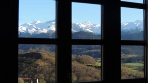 A view through a window with multiple panes, each displaying a different landscape. - Heredad de la Cueste (Llenín)