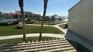A resort with a pool area, palm trees, and a view of the beach. - Enjoy beautiful sunset views (Sarasota)