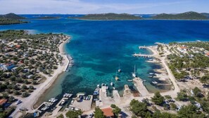 Overlooking a tranquil marina with docks and moorings, this coastal area offers stunning views of the surrounding landscape.