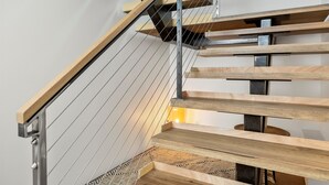 A modern staircase with wooden steps and metal railings. - NEW LISTING... Magnificent NEW Townhome, overlooking dt Hood River, garage (Hood River)