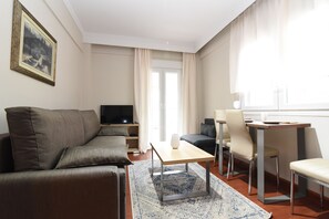 Relax in a stylish space with a sofa set, dining table, and flat-screen TV.